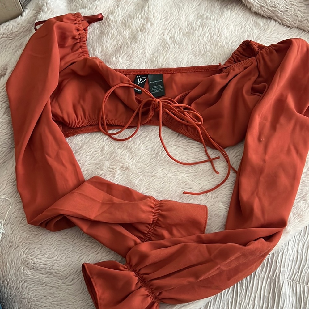 Burnt orange off the shoulder crop top, bow adjustable strings in the middle